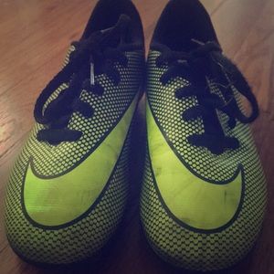 These are green and black soccer cleats.